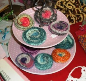 crochet brooches on cake stand